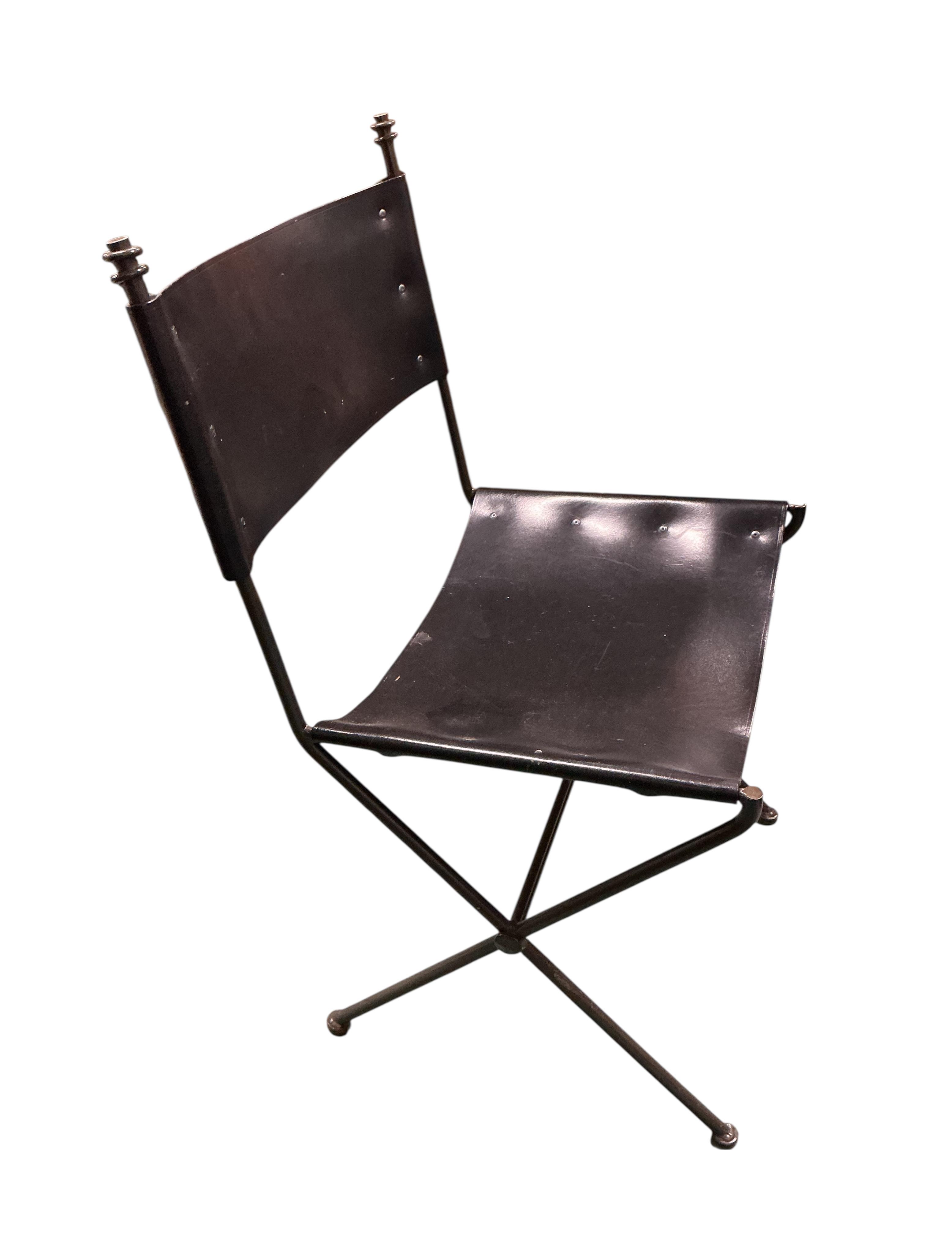 A set of seven mid century wrought iron leather chairs with 'X' frame stretchers, two with arms, width 55cm, depth 50cm, height 90cm